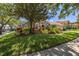 Well-manicured lawn and landscaping complement this charming single-story home with tile roof at 1855 Vista Royale Blvd, Orlando, FL 32835