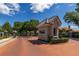 Vista Royale guard house with brick paved drive, mature trees, and gated entrance at 1855 Vista Royale Blvd, Orlando, FL 32835