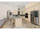 Well-equipped kitchen featuring stainless steel appliances and a cozy breakfast bar at 1855 Vista Royale Blvd, Orlando, FL 32835
