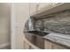 Well-appointed laundry room showcasing a stainless steel farmhouse sink and stone countertops at 1855 Vista Royale Blvd, Orlando, FL 32835