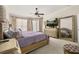 Comfortable main bedroom featuring a TV and large dresser at 1855 Vista Royale Blvd, Orlando, FL 32835