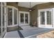 Covered patio features ceiling fan, outdoor seating, and double doors for seamless indoor-outdoor living at 1855 Vista Royale Blvd, Orlando, FL 32835