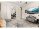 Comfortable sitting room with a TV, a plush armchair, and mirrored closet at 1855 Vista Royale Blvd, Orlando, FL 32835