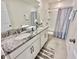 Bathroom with double sink vanity, granite countertop, tub/shower combo and neutral tile flooring at 2034 Fleming Mist Pl, Kissimmee, FL 34747
