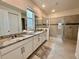 Beautiful bathroom with double vanity, granite countertop, and a glass-enclosed shower at 2034 Fleming Mist Pl, Kissimmee, FL 34747