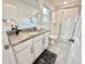 Bathroom featuring walk-in shower, white vanity with granite countertop, and decorative accents at 2034 Fleming Mist Pl, Kissimmee, FL 34747