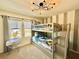 Bright ' bedroom with modern bunk beds, windows, and stylish decor and carpeted floor at 2034 Fleming Mist Pl, Kissimmee, FL 34747
