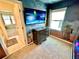 Unique themed bedroom with cosmic murals, a mounted TV, and an adjacent bathroom at 2034 Fleming Mist Pl, Kissimmee, FL 34747