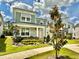 Beautifully landscaped front yard with flowering plants surrounding a charming two-story home at 2034 Fleming Mist Pl, Kissimmee, FL 34747