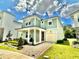 Charming two-story home featuring a covered porch, attached garage, and beautifully landscaped front yard at 2034 Fleming Mist Pl, Kissimmee, FL 34747