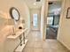 Inviting foyer with a stylish mirror, elegant lamps, and a glimpse into the main bedroom at 2034 Fleming Mist Pl, Kissimmee, FL 34747