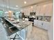 Modern kitchen featuring a large granite island, stainless steel appliances, and ample cabinet space at 2034 Fleming Mist Pl, Kissimmee, FL 34747