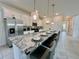 Modern kitchen boasts granite counters, stainless steel appliances, and breakfast bar with seating for seven at 2034 Fleming Mist Pl, Kissimmee, FL 34747