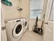 Functional laundry room with modern appliances, shelving, and ample storage space at 2034 Fleming Mist Pl, Kissimmee, FL 34747