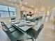 Open-concept living space featuring dining area, kitchen, and a large countertop with bar stools at 2034 Fleming Mist Pl, Kissimmee, FL 34747