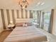 Cozy main bedroom featuring a queen bed, TV, neutral decor, and carpeted floors at 2034 Fleming Mist Pl, Kissimmee, FL 34747