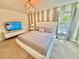 Cozy main bedroom featuring a queen bed, TV, neutral decor, and carpeted floors at 2034 Fleming Mist Pl, Kissimmee, FL 34747