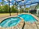 Screened-in pool and spa with brick pavers, offering a relaxing outdoor oasis at 2034 Fleming Mist Pl, Kissimmee, FL 34747