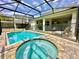Outdoor pool and spa in screened-in enclosure. Backyard also features a covered patio area at 2034 Fleming Mist Pl, Kissimmee, FL 34747