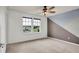 Bright bedroom featuring neutral carpet, a modern accent wall, and bright, natural lighting at 2203 Bluebird Pl, St Cloud, FL 34771