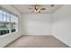 Spacious bedroom with a large window, ceiling fan, and neutral carpeting at 2203 Bluebird Pl, St Cloud, FL 34771