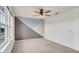 Spacious bedroom with neutral carpet, ample natural light, and a modern ceiling fan at 2203 Bluebird Pl, St Cloud, FL 34771