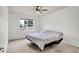 Carpeted bedroom with a ceiling fan and window providing natural light, creating a serene and comfortable space at 2203 Bluebird Pl, St Cloud, FL 34771