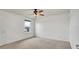 Spacious bedroom features neutral carpet, a ceiling fan, and bright, natural lighting at 2203 Bluebird Pl, St Cloud, FL 34771
