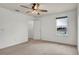 Bright and open bedroom showcasing neutral carpet, a walk-in closet, and plenty of natural lighting at 2203 Bluebird Pl, St Cloud, FL 34771