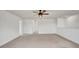 Spacious bonus room featuring neutral carpet, a ceiling fan, and bright natural light at 2203 Bluebird Pl, St Cloud, FL 34771