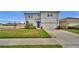 Charming two-story home featuring a well-maintained lawn and attached two-car garage at 2203 Bluebird Pl, St Cloud, FL 34771