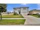 Charming two-story home with a well-manicured lawn and a two-car garage at 2203 Bluebird Pl, St Cloud, FL 34771