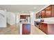 Well-equipped kitchen boasts stainless steel appliances, dark wood cabinetry, and a center island with sink at 2203 Bluebird Pl, St Cloud, FL 34771