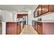 Modern kitchen with stainless steel appliances, dark wood cabinets, and tile floors at 2203 Bluebird Pl, St Cloud, FL 34771