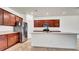 Well-equipped kitchen with stainless steel refrigerator and a large island with seating at 2203 Bluebird Pl, St Cloud, FL 34771