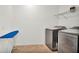 Laundry room showcases modern washer and dryer, an ironing board, and wire shelving at 2203 Bluebird Pl, St Cloud, FL 34771