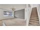 Cozy living room with a ceiling fan, stairs, carpet, and natural light at 2203 Bluebird Pl, St Cloud, FL 34771
