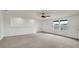 Open living room offers neutral carpet, large windows, and an overhead fan at 2203 Bluebird Pl, St Cloud, FL 34771