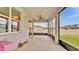 View of the screened-in porch with large windows overlooking the backyard and surrounding neighborhood at 2203 Bluebird Pl, St Cloud, FL 34771