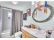 Well-lit bathroom featuring a vanity with ample counter space, modern fixtures, and a shower with curtain rod at 227 Morning Glory Dr, Lake Mary, FL 32746