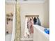Functional bathroom with a shower, decorative shower curtain, and a convenient rack for organizing towels and clothing at 227 Morning Glory Dr, Lake Mary, FL 32746