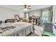 Cozy bedroom with a ceiling fan, a comfortable bed, ample natural light, and shelving for storage and decor at 227 Morning Glory Dr, Lake Mary, FL 32746