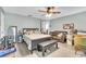 Bedroom with ceiling fan, wood-look floors, and a leather sofa at 227 Morning Glory Dr, Lake Mary, FL 32746