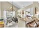 Dining area and kitchen featuring tile floors and granite countertops at 227 Morning Glory Dr, Lake Mary, FL 32746