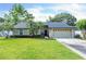Charming single-story home featuring a lush green lawn, well-maintained landscaping, and an attached two-car garage at 227 Morning Glory Dr, Lake Mary, FL 32746