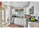 Modern kitchen with white cabinets, stainless appliances, and granite counters at 227 Morning Glory Dr, Lake Mary, FL 32746