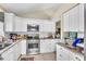 Bright kitchen featuring white cabinets, stainless steel appliances, and granite countertops at 227 Morning Glory Dr, Lake Mary, FL 32746