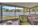 Relaxing screened porch with outdoor seating, offering a view of the spacious backyard and privacy fence at 227 Morning Glory Dr, Lake Mary, FL 32746
