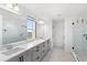 Modern bathroom with double sink vanity, glass shower, and stylish marble-like tile floors at 2294 Gold Dust Dr, Minneola, FL 34715