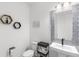 Chic half bath with unique mirror, stylish sink and fixtures, and decorative wall hangings at 2294 Gold Dust Dr, Minneola, FL 34715
